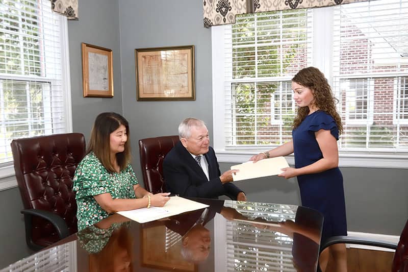 Photo of the legal professionals of the Bryan & O'Connor Law Firm in the office conference room